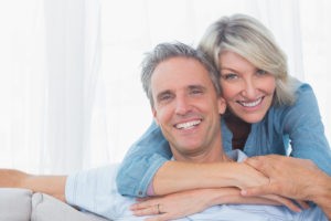 Couple happily smiling in living room